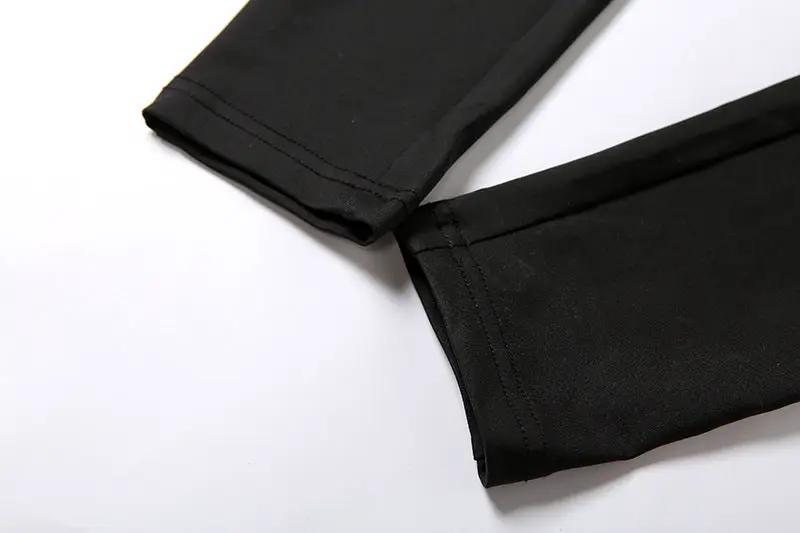Black pencil jumpsuit fabric close-up with visible seam stitching