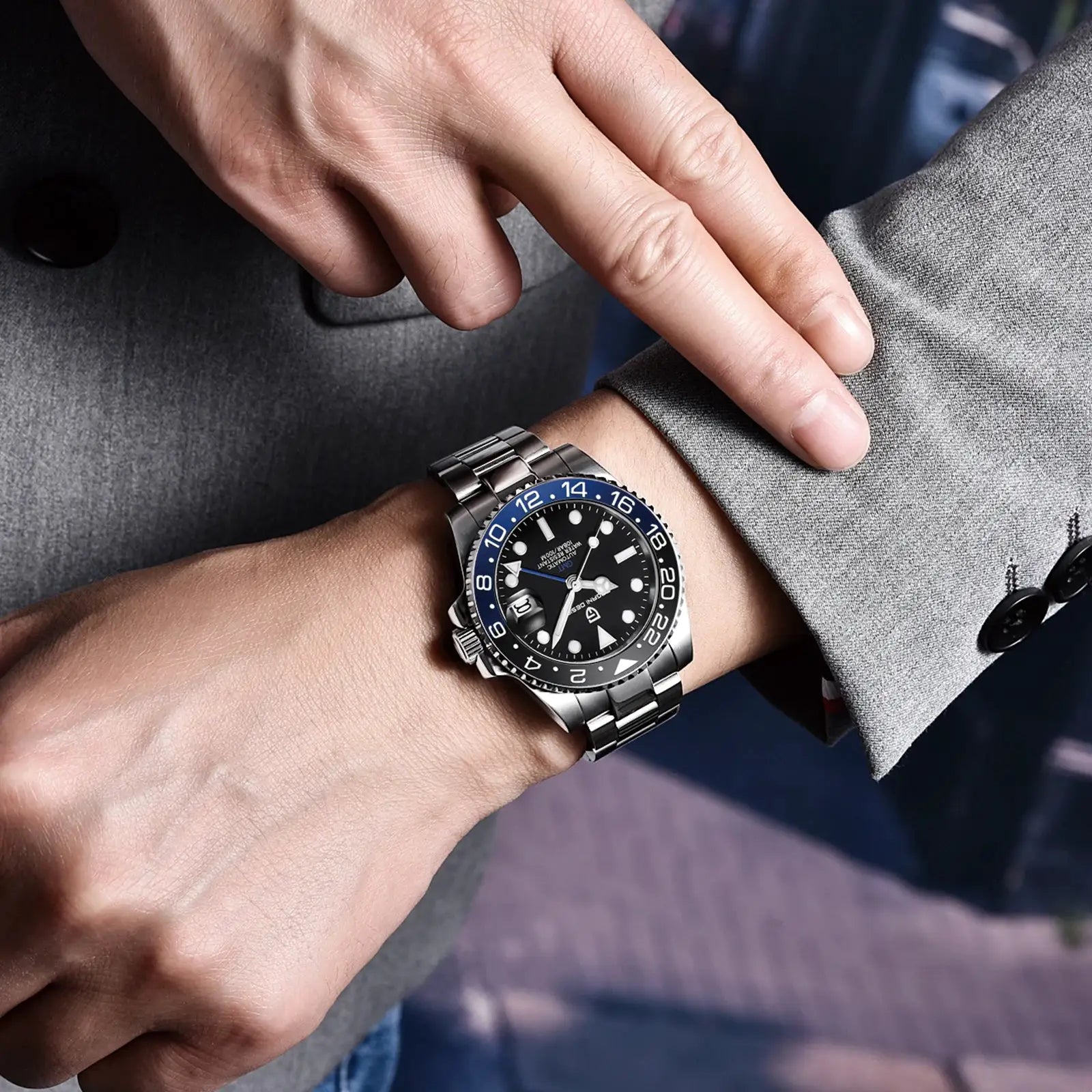 PAGANI DESIGN luxury men's GMT watch with stainless steel bracelet and blue bezel on the wrist