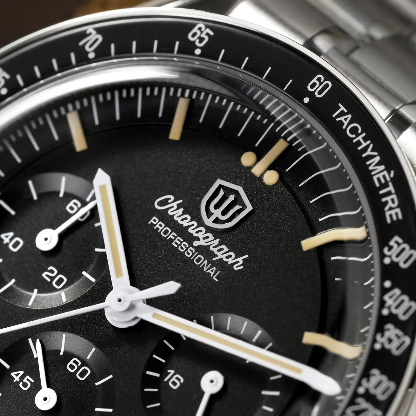 Chronograph watch with black dial, beige lume markers, white hands and stainless steel bracelet with tachymeter bezel