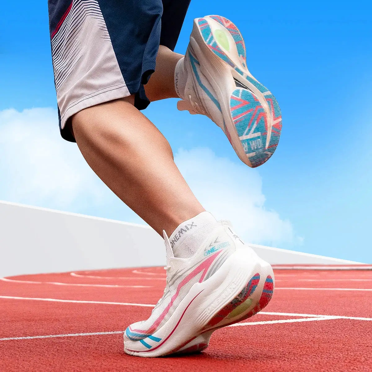 ONEMIX marathon carbon-plate running shoes, white with blue and pink accents, worn on a track