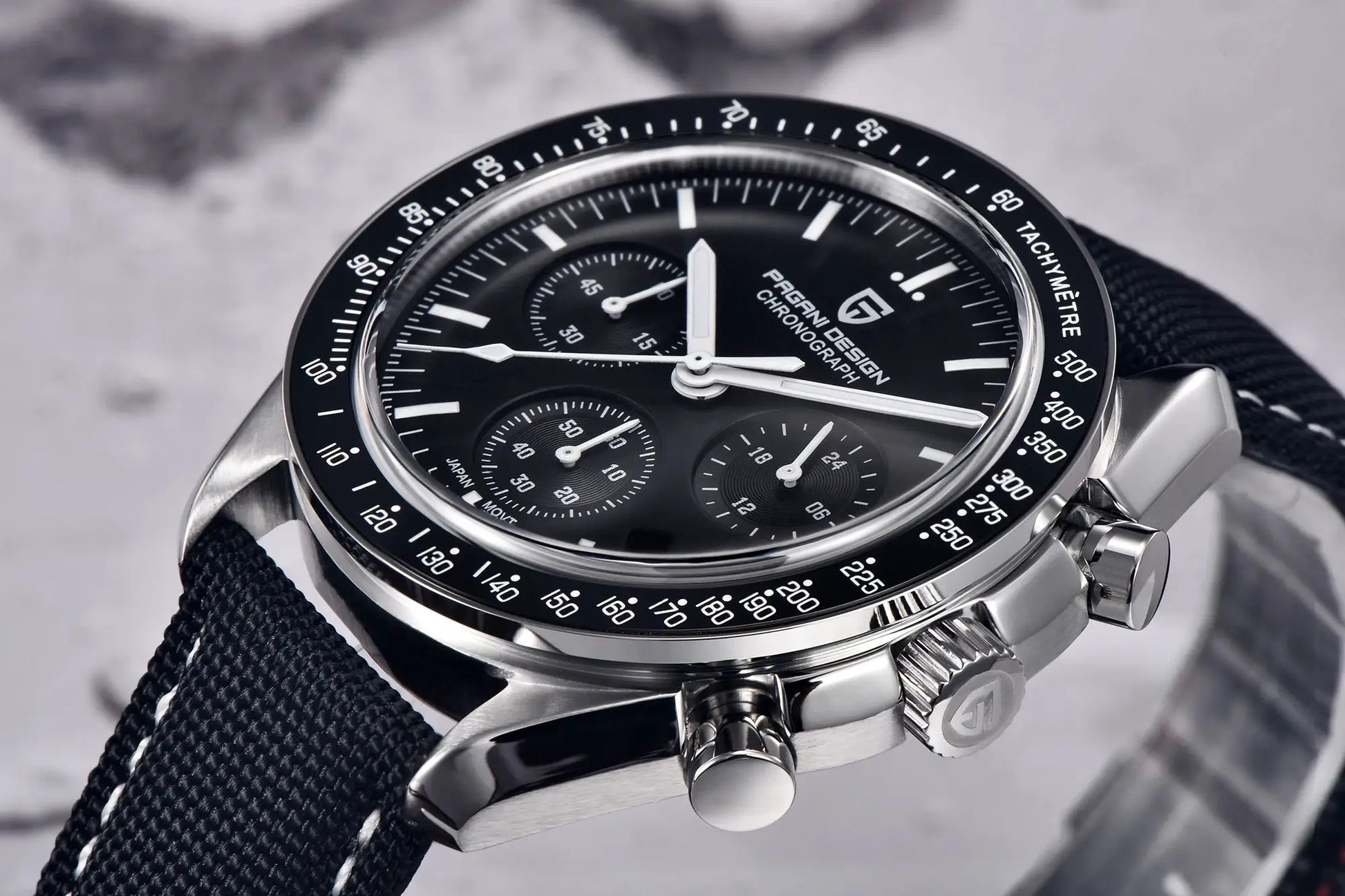 Pagani Design men's chronograph watch with black dial, tachymeter bezel, silver case, and black woven strap