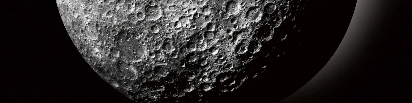 Moon surface close-up showing cratered terrain against a dark background