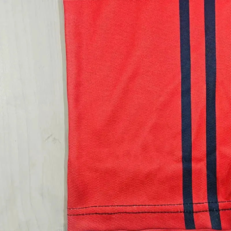 Men's red polo shirt with navy double stripes along the side, short sleeves