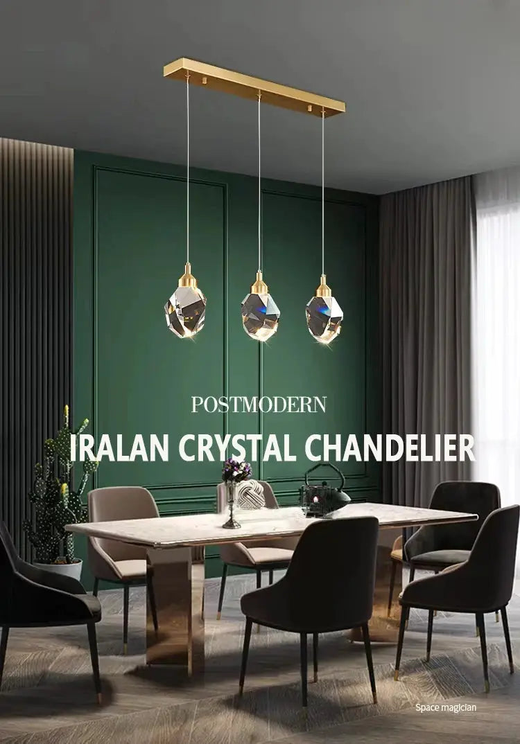 Three crystal pendant chandelier with gold fittings hanging from a gold ceiling bar over a dining table