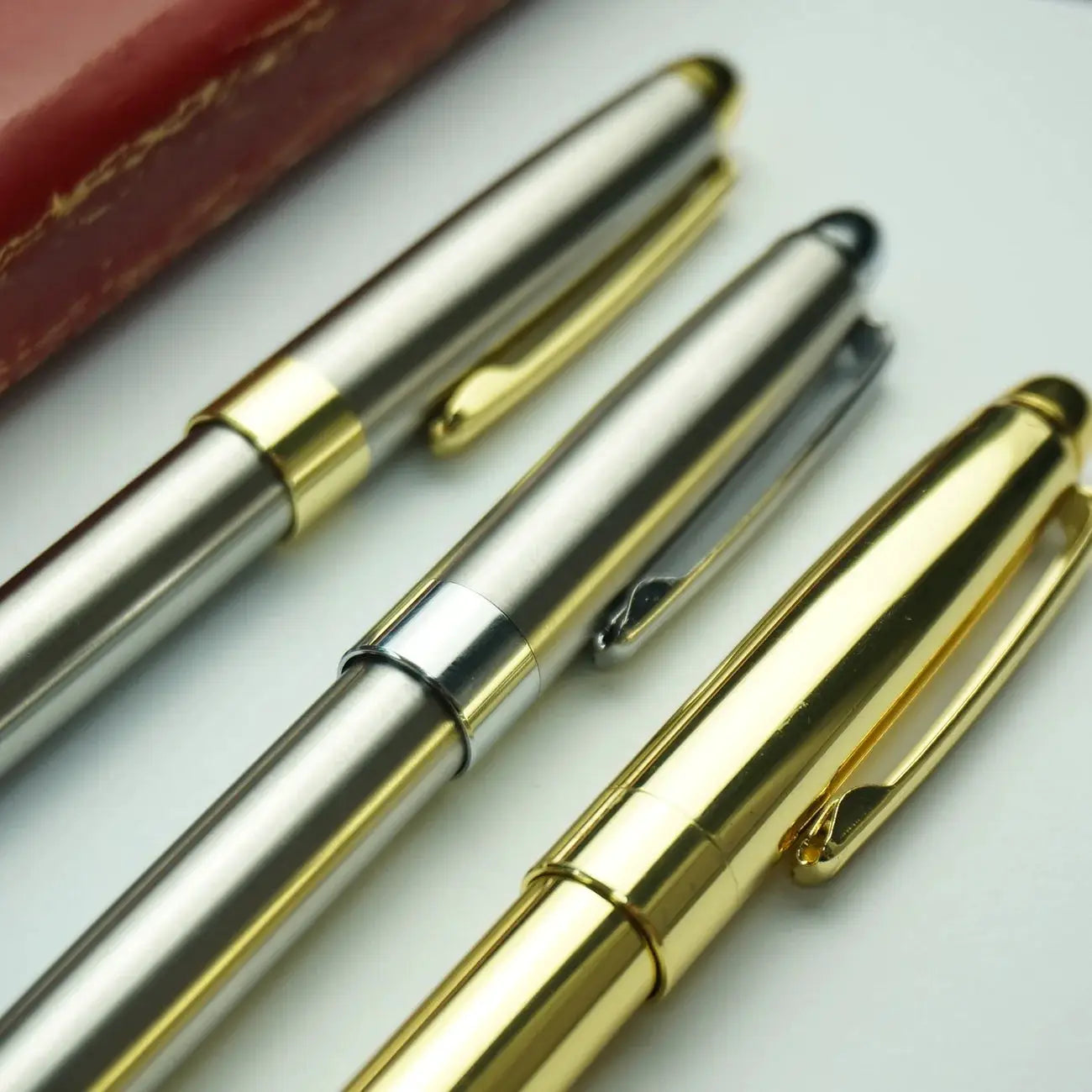 Simples Market ballpoint pen set of four with retractable silver and gold metal bodies and clips