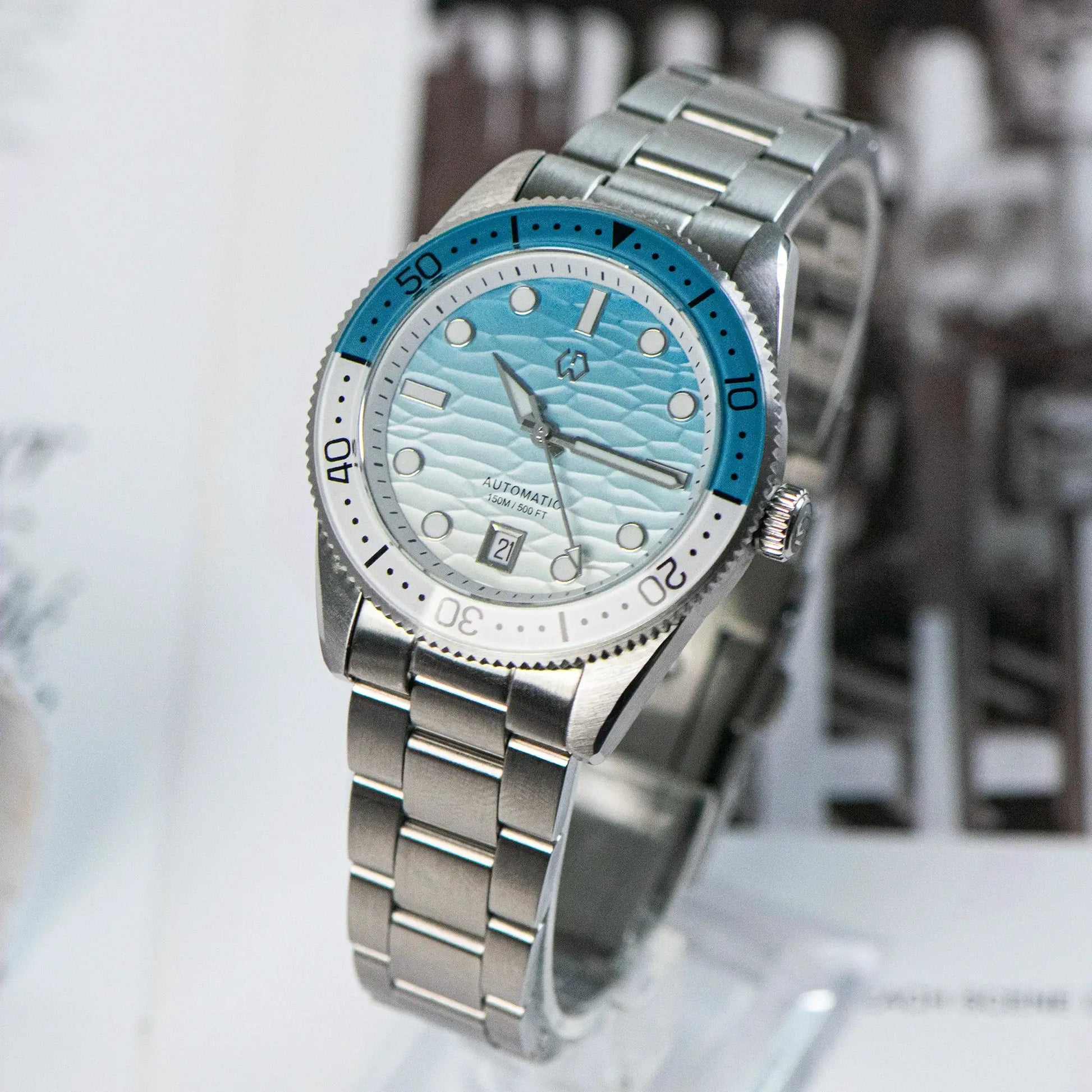 WISHDOIT men's automatic dive watch with ocean blue bezel and white ripple dial, stainless steel bracelet.