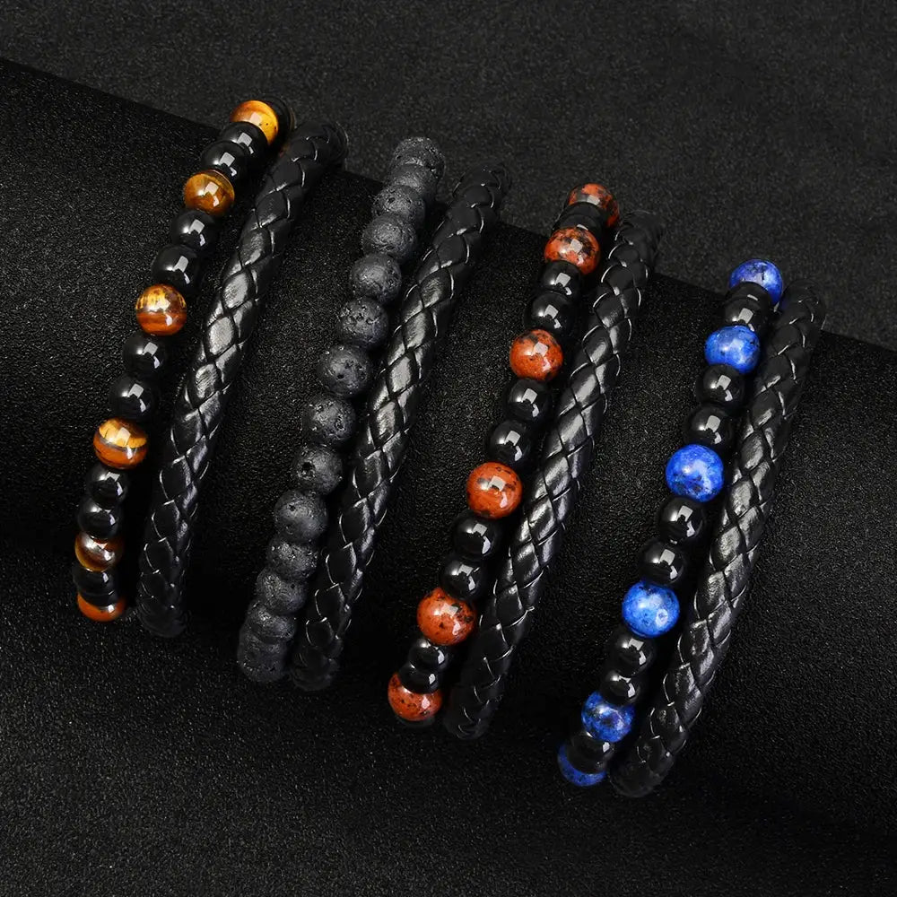 Five unisex beaded bracelets with black braided bands and tiger eye, lava stone, red jasper, and blue lapis beads