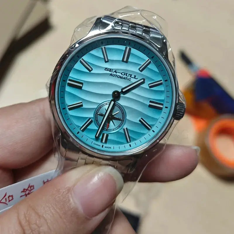 Sea-Gull Natural Series men's watch with turquoise dial, stainless steel bracelet, automatic movement.