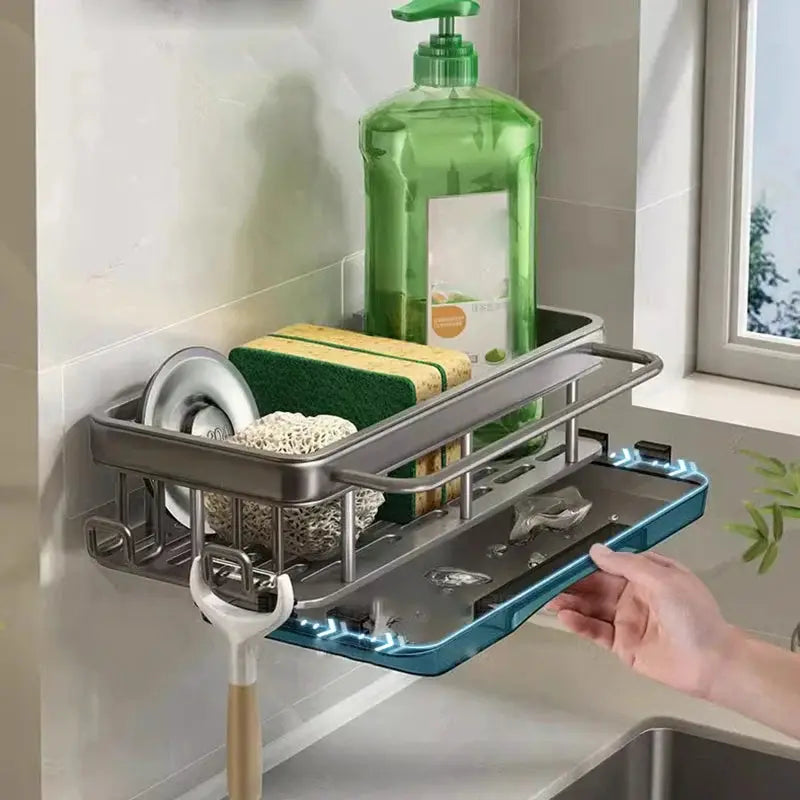 Wall-mounted kitchen drain rack with blue pull-out tray; gray metal frame holds sponge, brush, and dish soap.