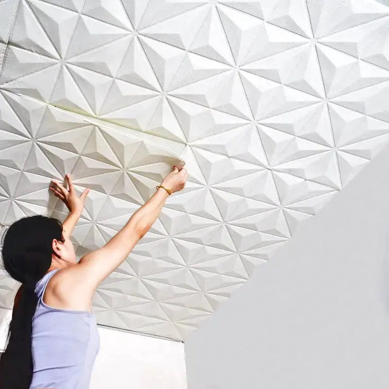 35x35cm 3D foam self-adhesive wall and ceiling stickers, white geometric tiles being applied.