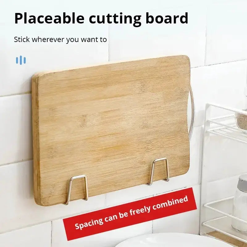 Wooden cutting board wall-mounted with two metal hooks for hanging and drying kitchen accessories