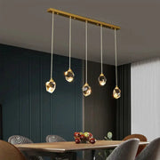 Ceiling pendant lamp set of 5 crystal pendants with a gold bar for modern dining room lighting.