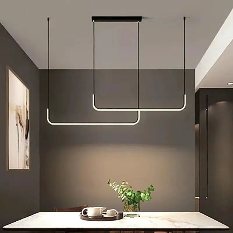 Modern LED strip chandelier light in gold finish with two hanging pendants over marble dining table