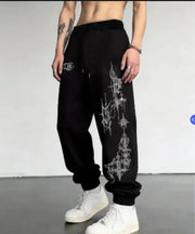 Men's black joggers with spiked cross print on the leg, drawstring waist, cuffed ankles by Simples Market