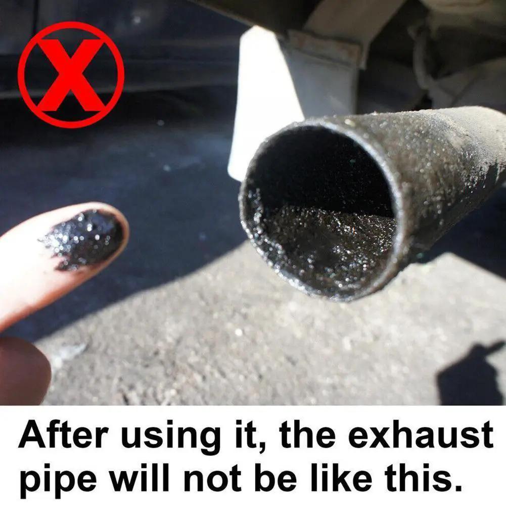 Catalytic converter cleaner for cars; close-up of a blackened exhaust pipe with soot and a dirty finger