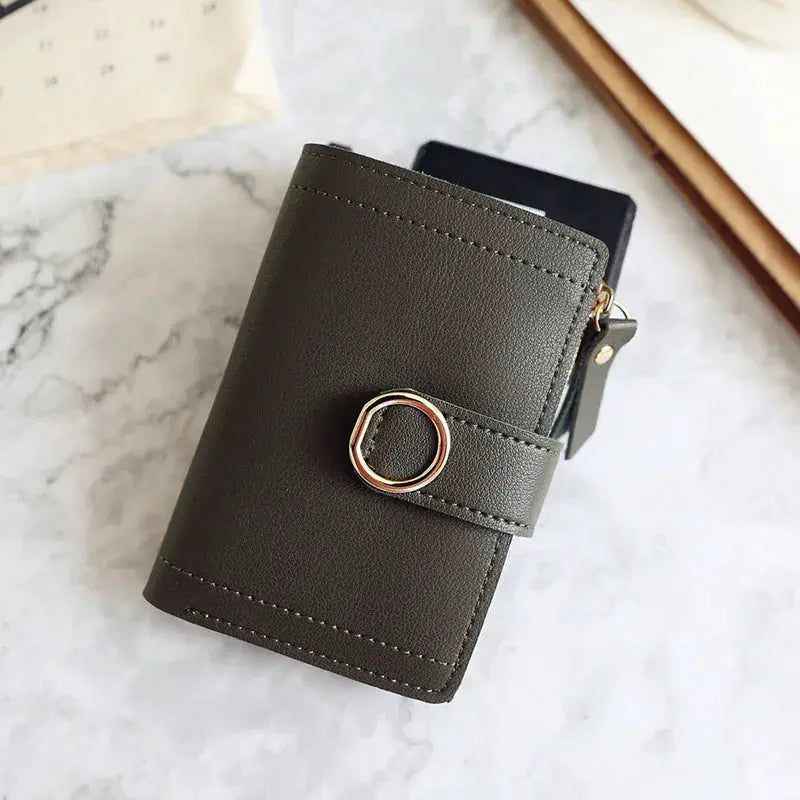 Compact women's PU leather wallet by Simples Market with strap and ring clasp in dark gray.