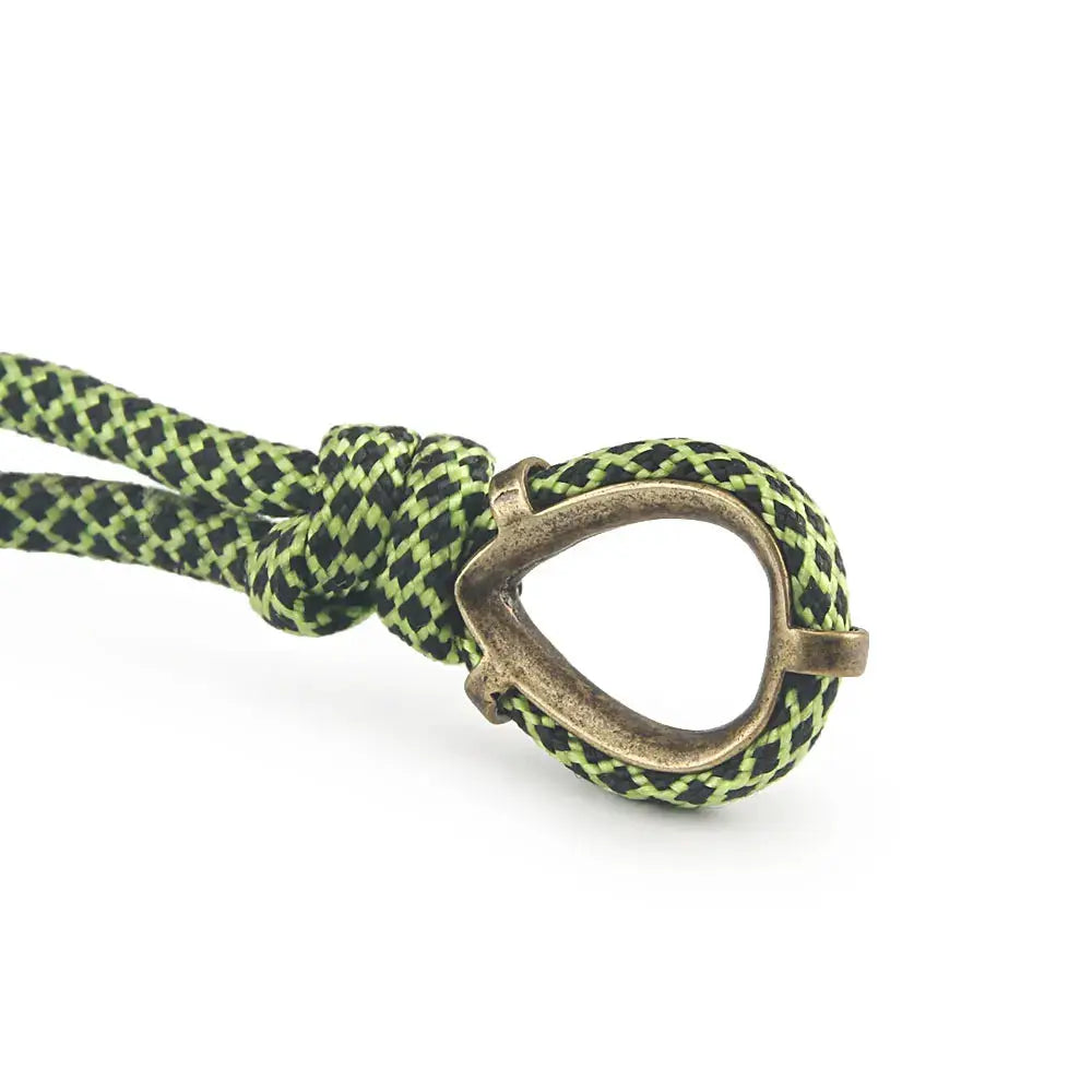 Paracord keychain with a brass ring on green and black braided cord