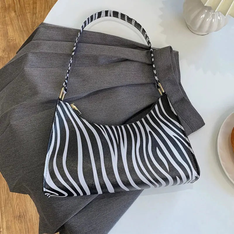 Shoulder bag Simples Market zebra print PU leather, black-and-white striped handbag.