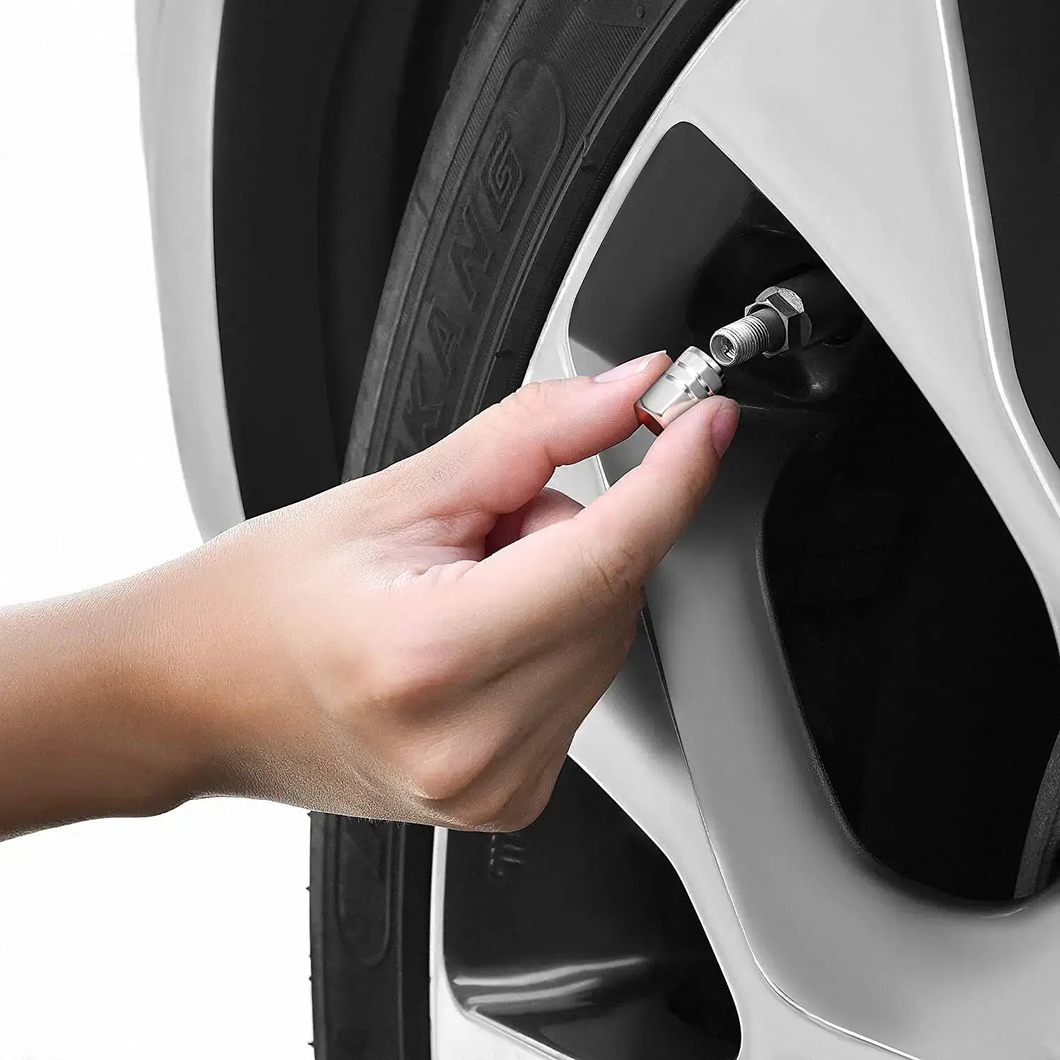 AUTCOAT aluminum alloy tire valve caps being installed on a car wheel; silver metal caps