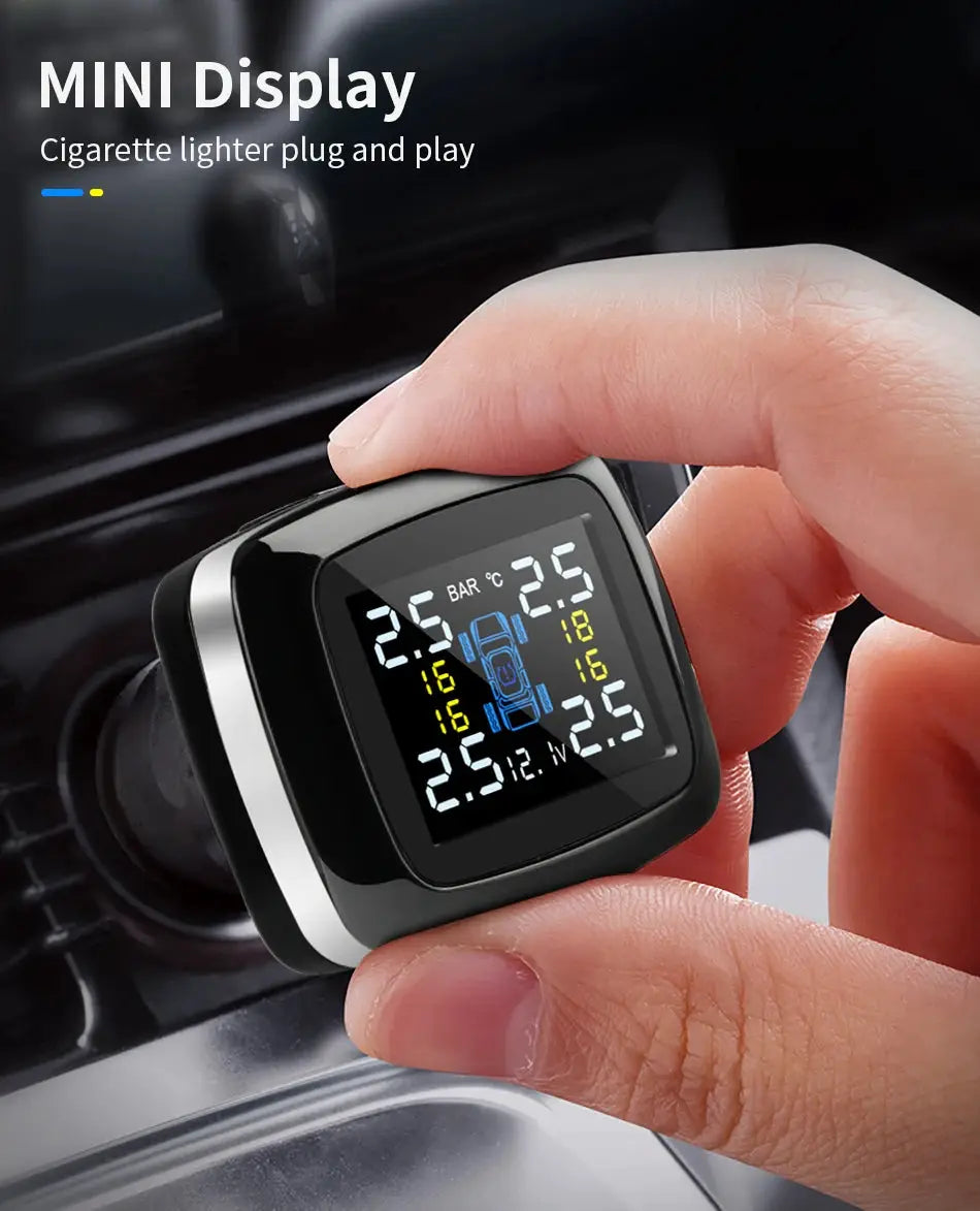 Car TPMS display unit showing tire pressure readings; black with silver trim