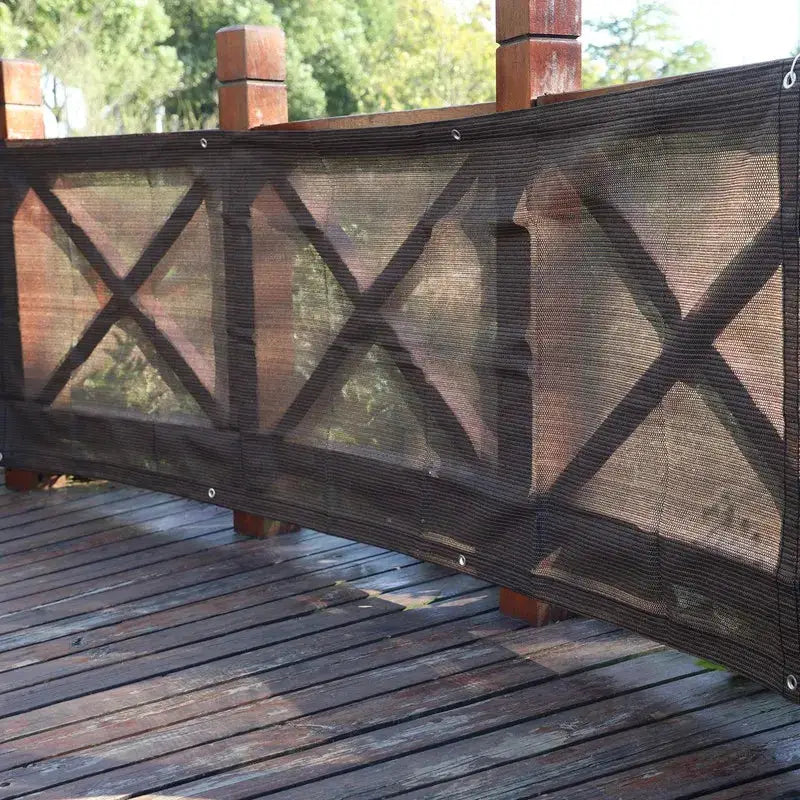 Tewango HDPE sun shade net, black anti-UV privacy screen along wooden balcony railing.