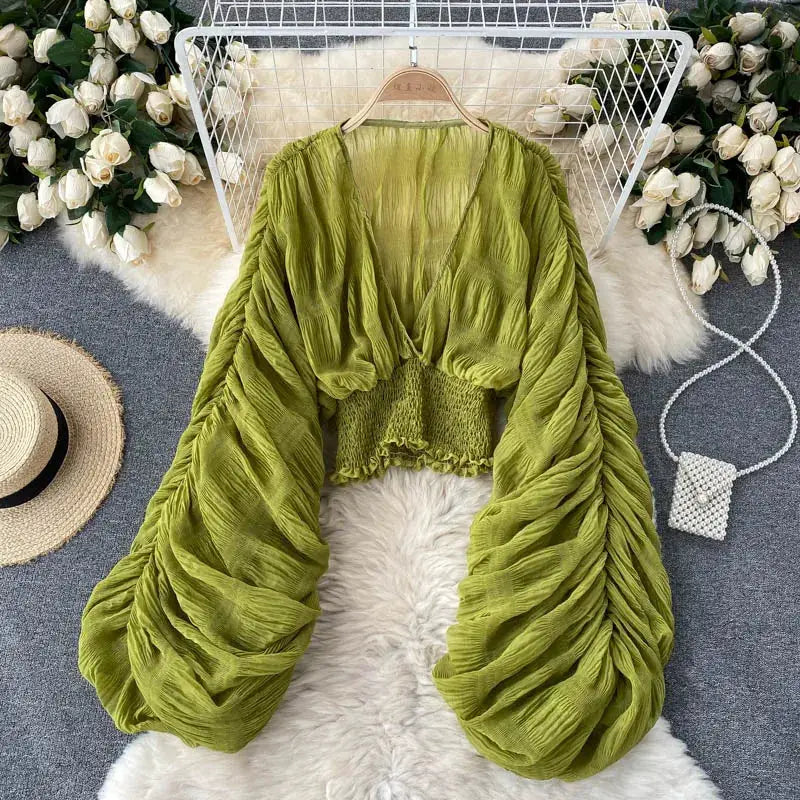Green draped chiffon blouse for women with V-neck, puff long sleeves and smocked cropped waist, stylish summer top.