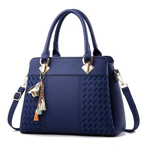 Handbag in blue PU leather by Simples Market with tassel charms, top handles, and detachable crossbody strap
