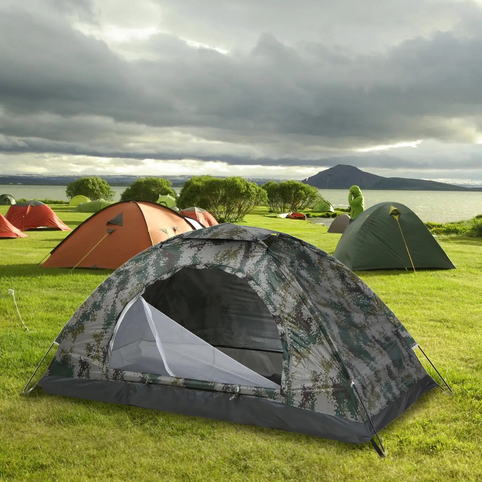 Tomshoo ultralight 1/2 person camping tent in digital camouflage on a grassy lakeside campground