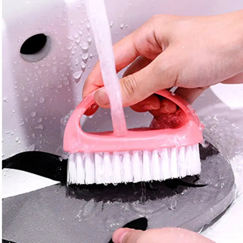 Egg-shaped pink cleaning brush with white bristles, handheld household scrubber.