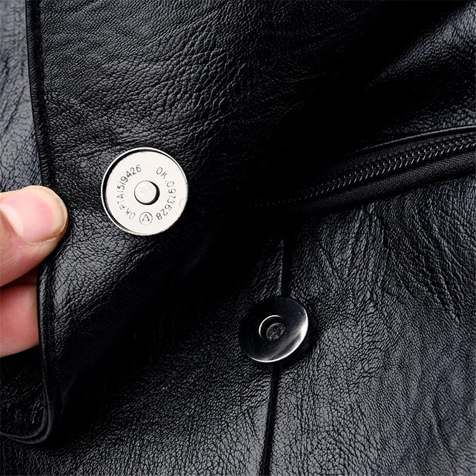 Leather backpack in black with metal snap closure and zip pocket detail