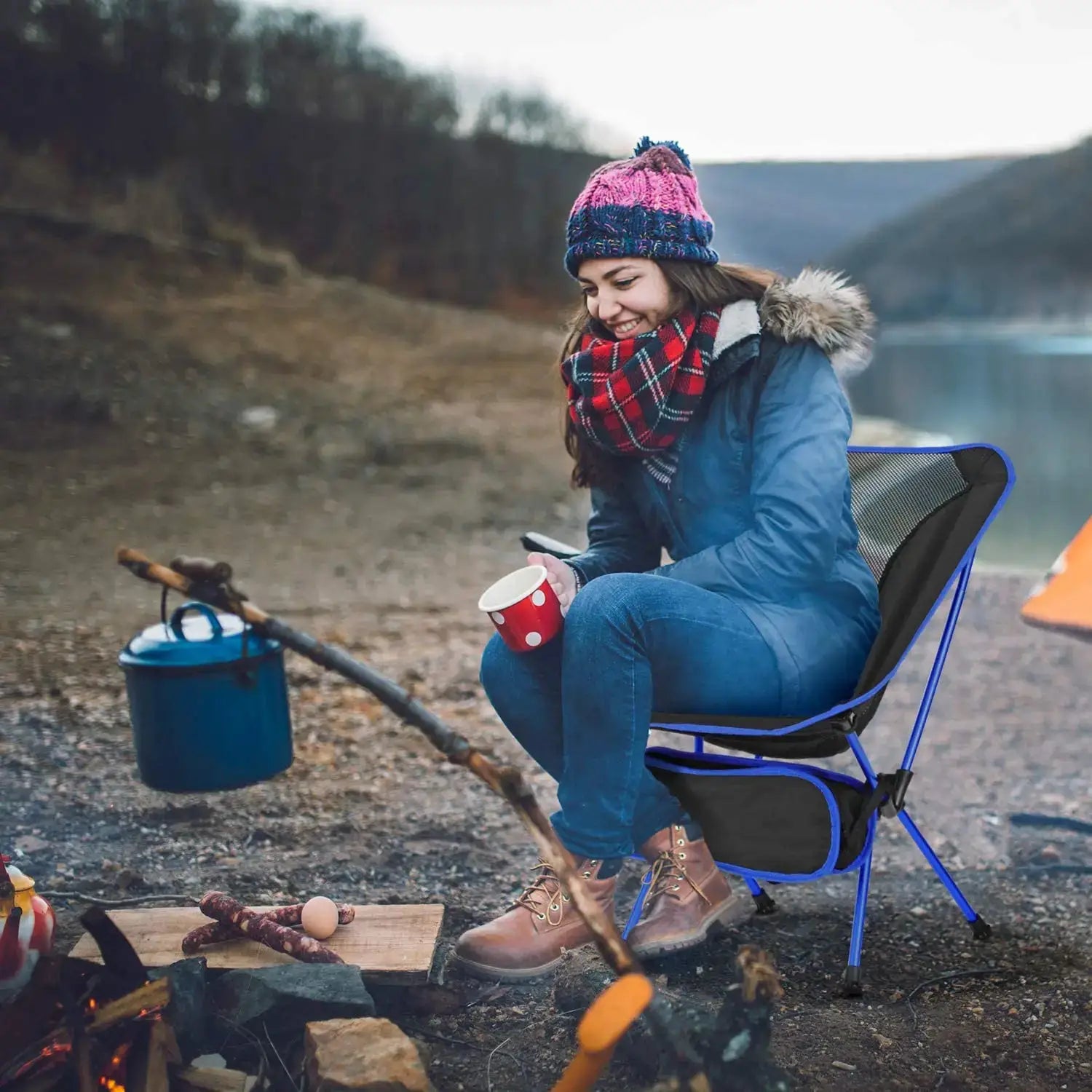 Folding camping chair with blue frame and black mesh seat, ultralight and portable