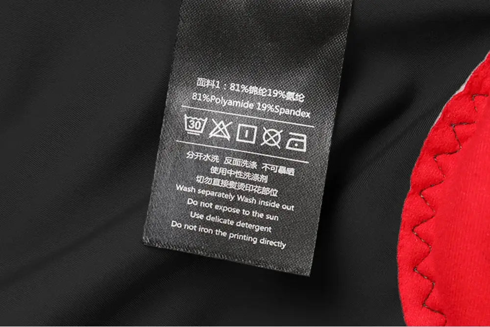 RION men's cycling shorts, black fabric with red panel; care tag visible.