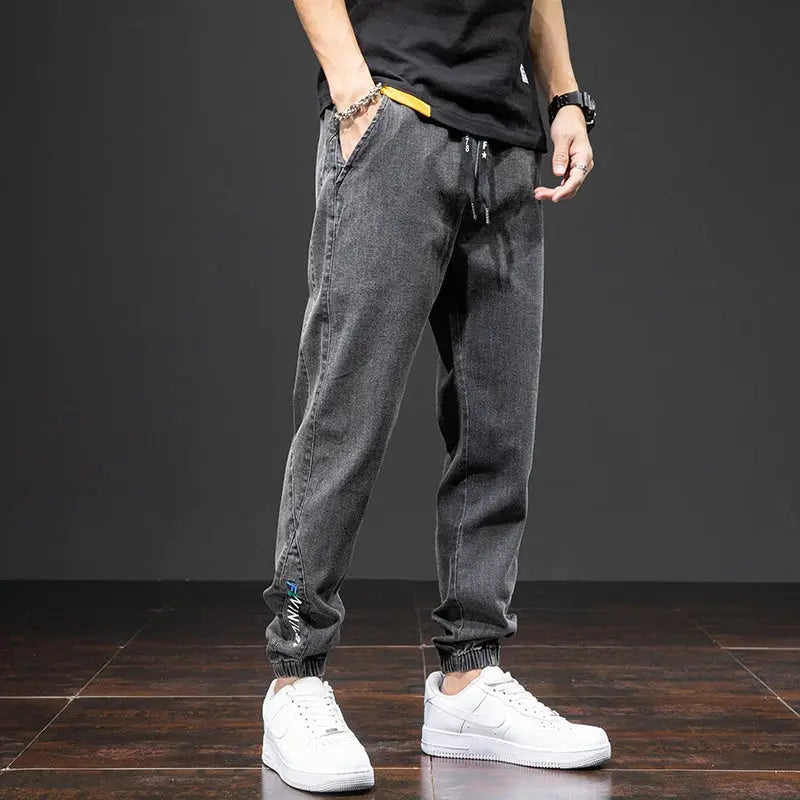 Men's gray denim cargo jogger jeans with drawstring waist and elastic cuffs