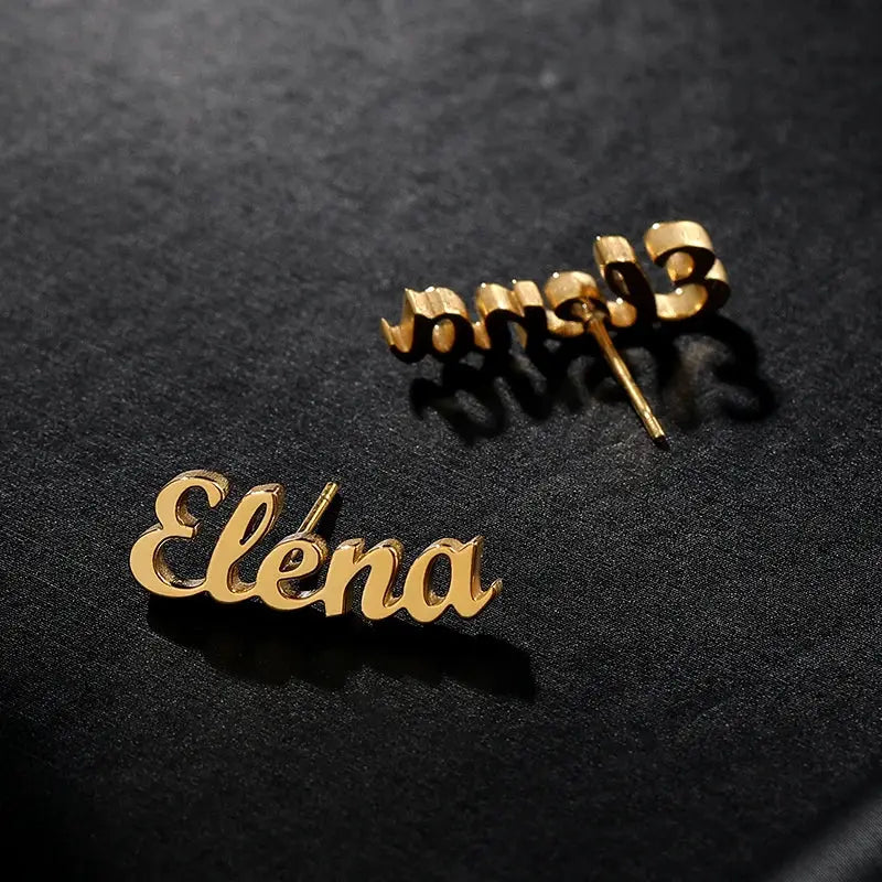 1 pair of gold-tone custom name earrings with Elena script, stainless steel nameplate studs