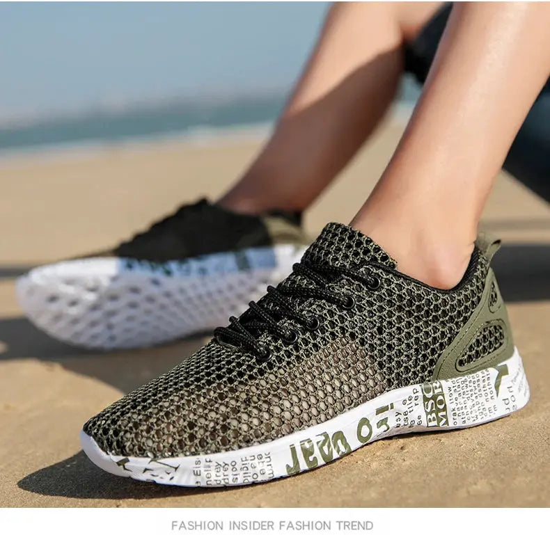 Men's mesh sneakers by Simples Market on beach, black-green breathable upper with newspaper-printed foam sole