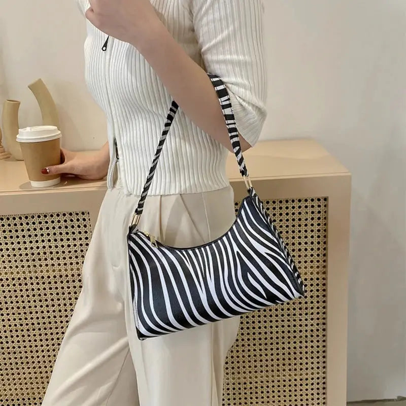 Shoulder bag by Simples Market in zebra print PU leather with striped strap