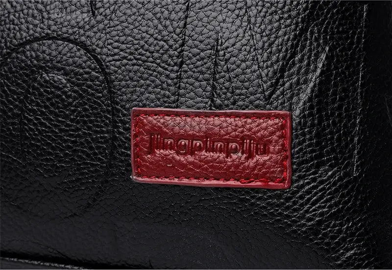 PU leather crossbody bag, black pebbled texture with red Jingpunlu logo patch