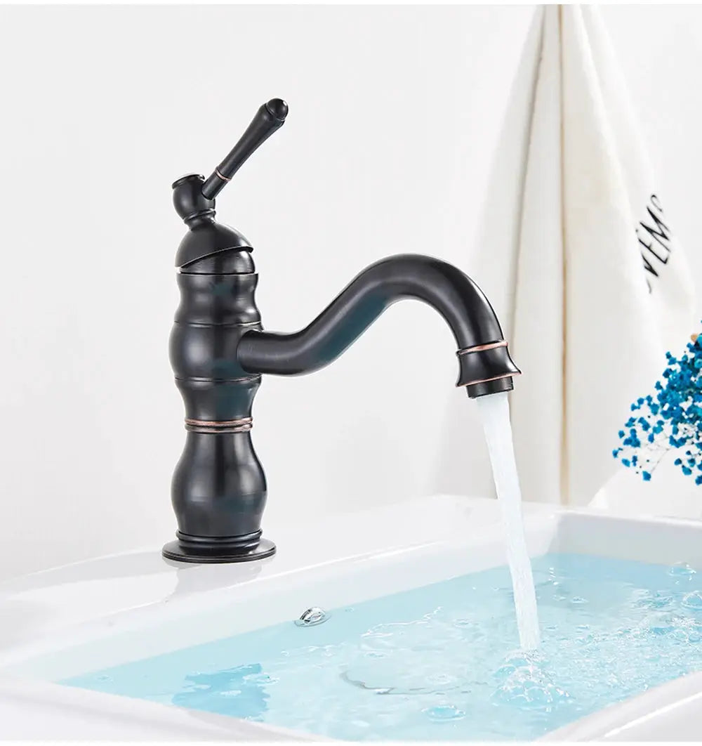 Antique brass basin faucet, deck-mounted single-hole mixer tap with curved spout for bathroom.