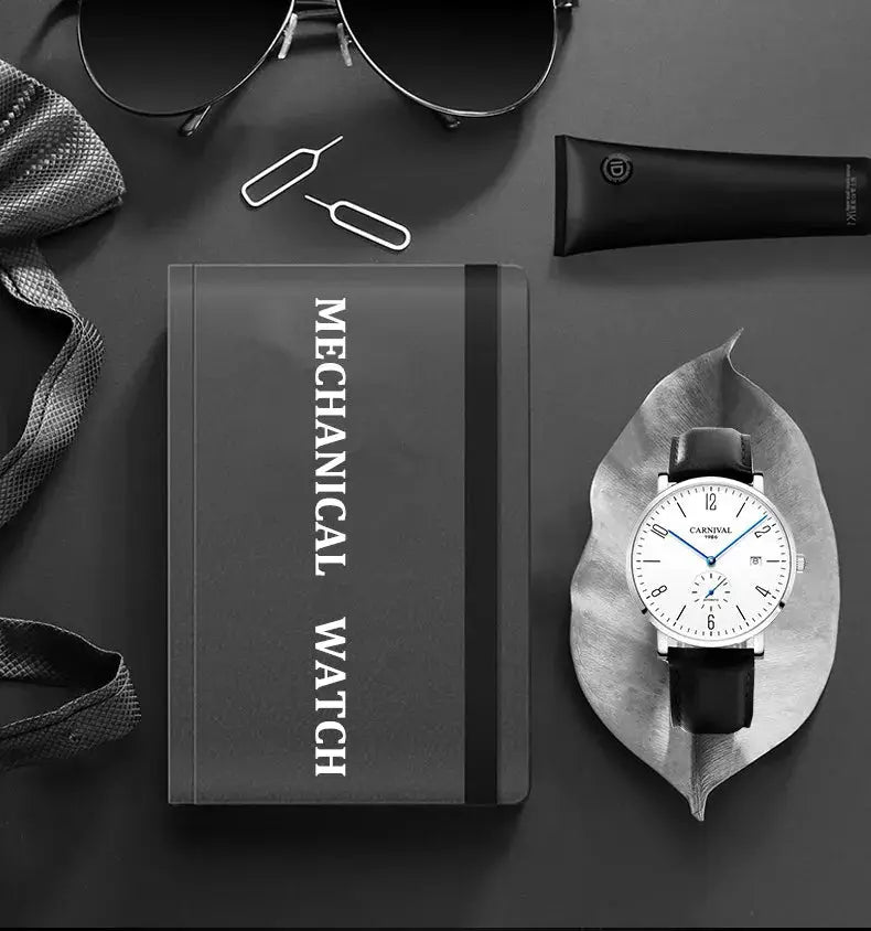Carnival mechanical wristwatch for men with white dial and black leather strap, displayed beside a MECHANICAL WATCH box.