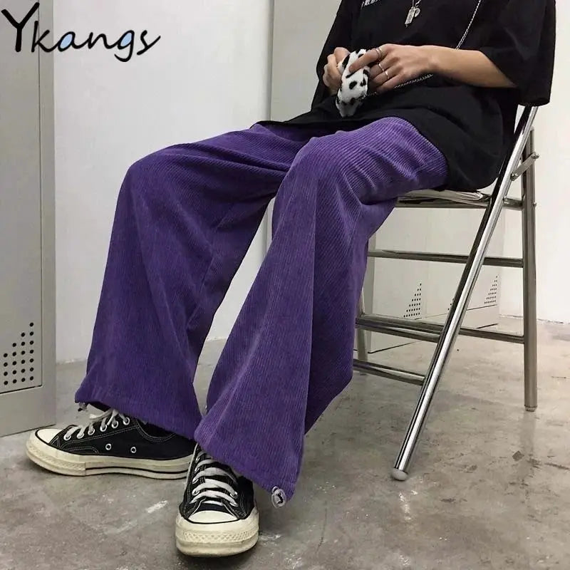 Simples Market women's outfit: purple corduroy wide-leg pants with black oversized top and sneakers