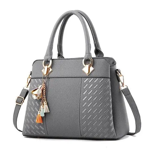 Simples Market gray PU leather tote bag with tassel charms, top handles and crossbody strap