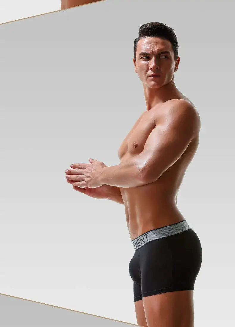 Boxer briefs, black with gray waistband, on a male model