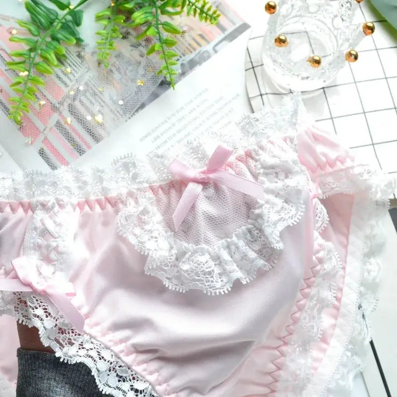 Pink milk-silk panties with white lace trim and pink bows, low-rise briefs