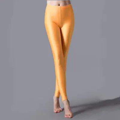 Women's shiny fluorescent orange leggings made from spandex for casual wear.