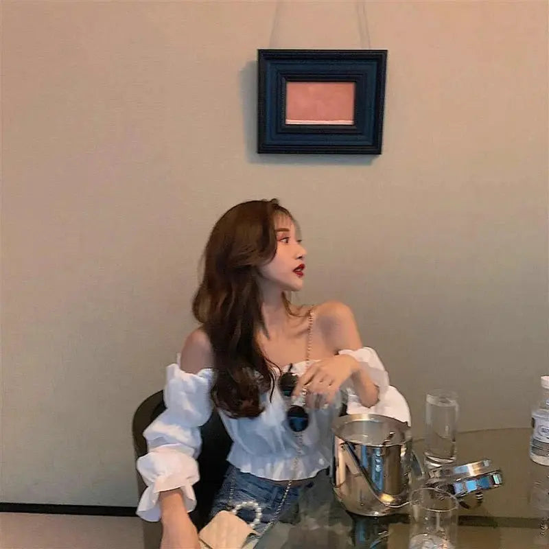 White off-shoulder puff-sleeve cropped top shown on model