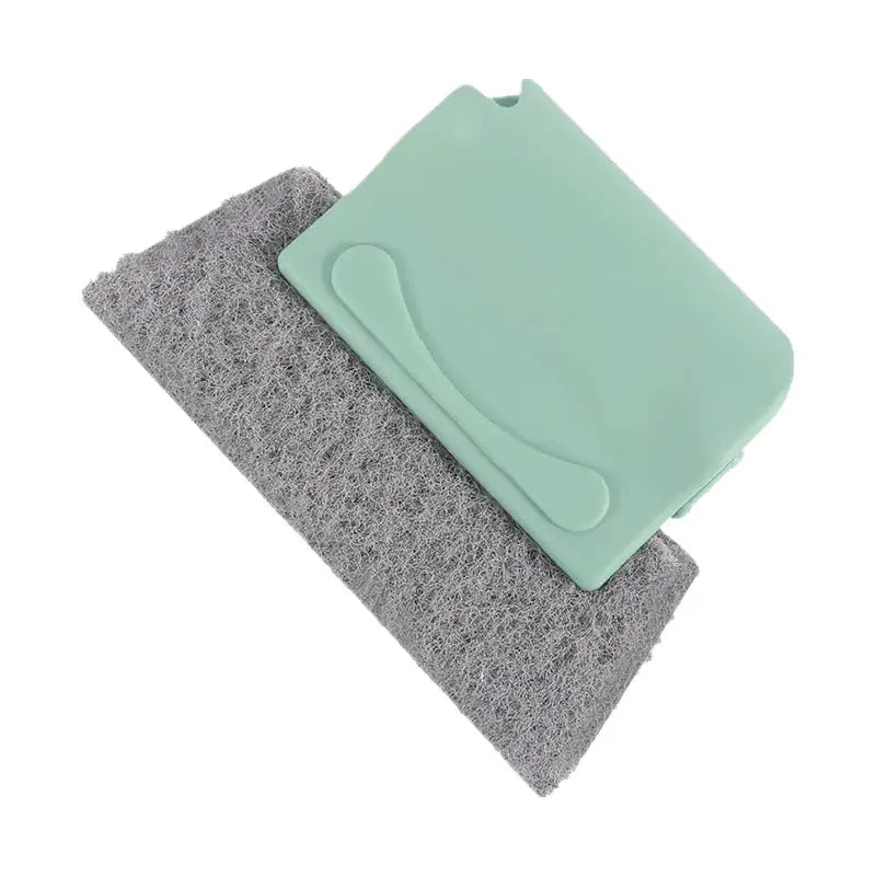 Groove cleaning brush by Simples Market with green plastic body and gray scrubbing pad