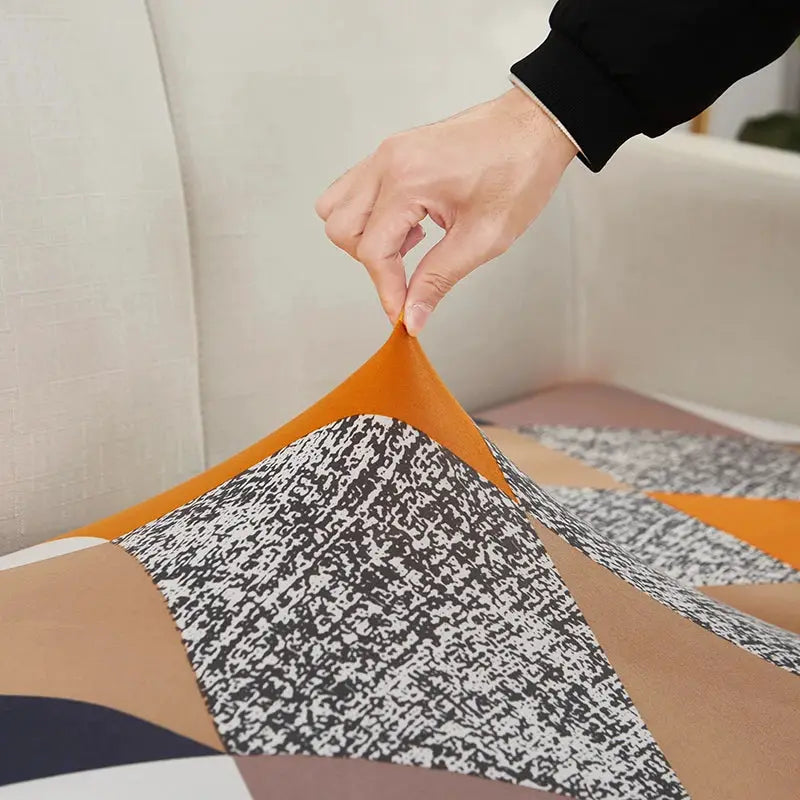 geometric print sofa cover with elastic corner slipcover in orange and tan tones