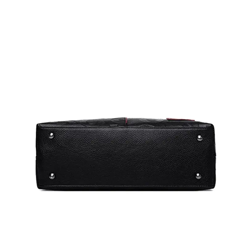 Simples Market PU leather crossbody bag in black with metal stud feet on bottom.
