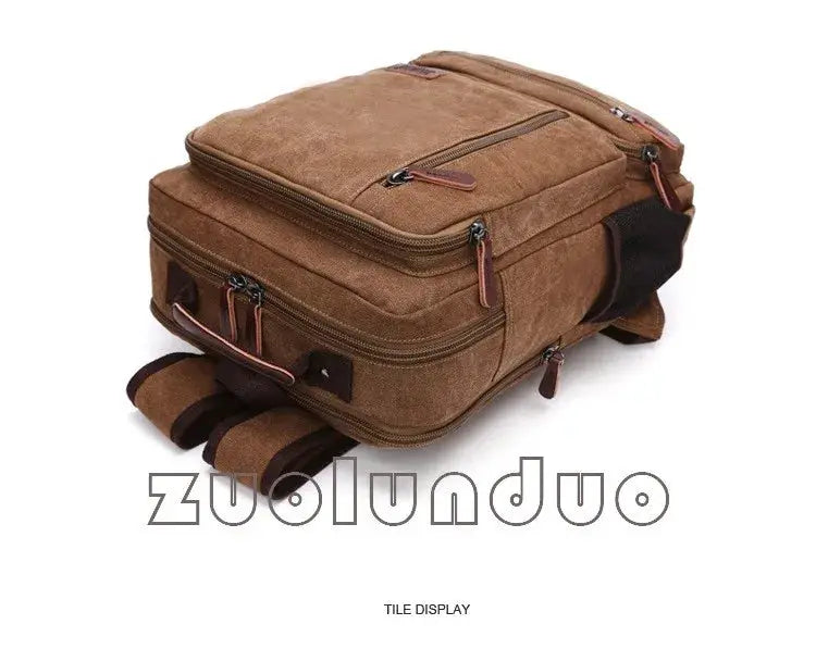Vintage brown canvas backpack with leather zipper pulls and multiple zip pockets.