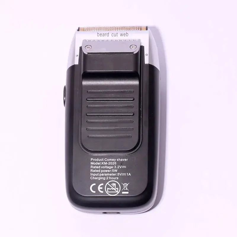 Kemei electric shaver back view with ribbed grip and charging label, black portable razor